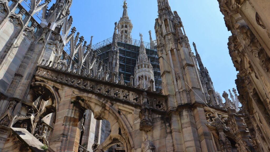 Gothic spires and architectural details on the rooftop of the Duomo di Milano in Italy
