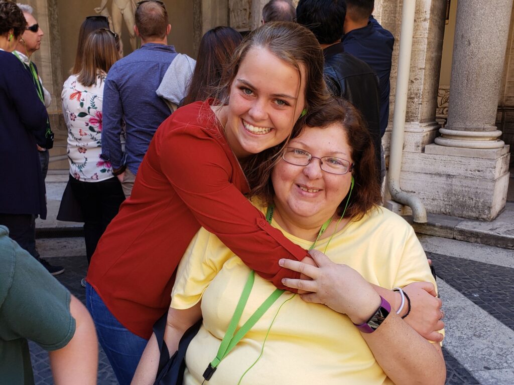 Tara smiling with travel friends in the Octagonal Court of the Vatican Museums.