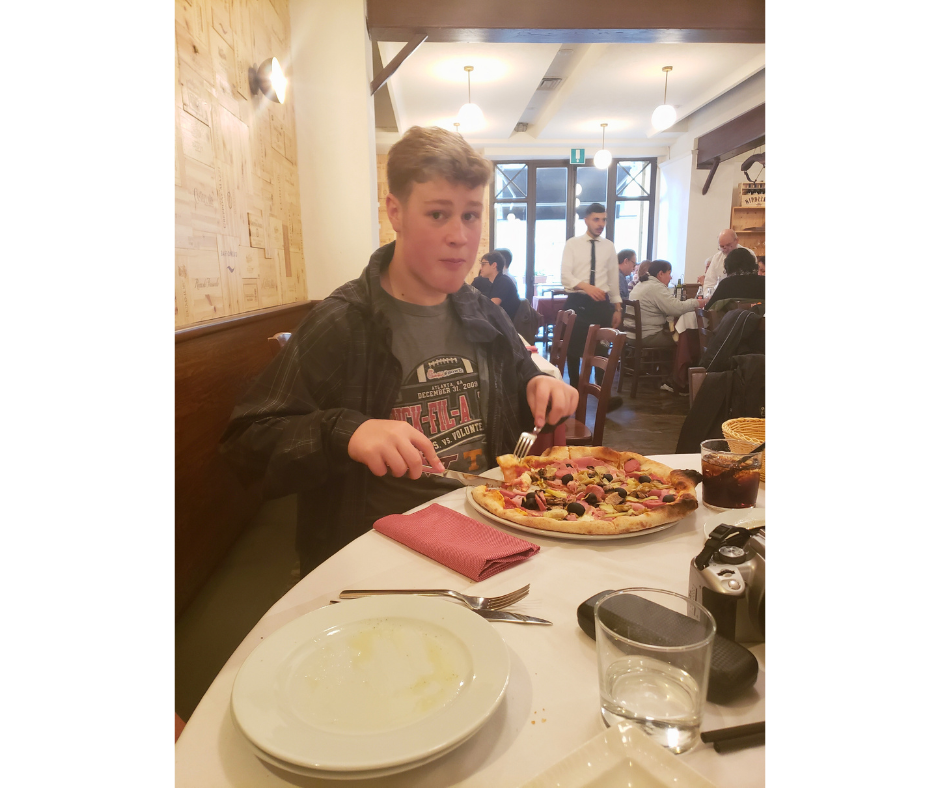 My son eating a delicious pizza.