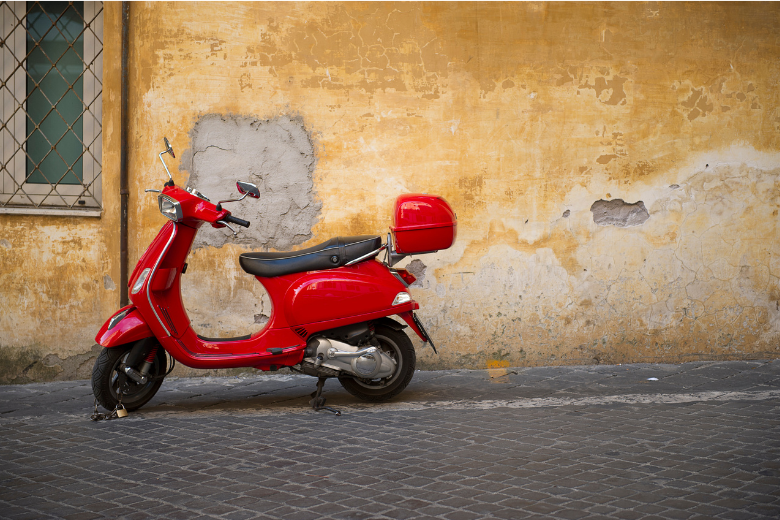 the red scooter on cobblestones