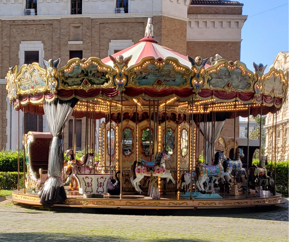 The carousel with cobblestones in the foreground